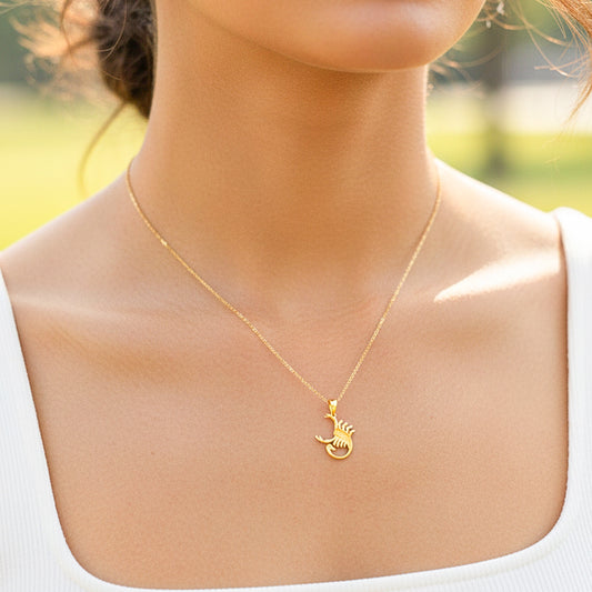Cuello de modelo usando una cadena con un dije en forma del signo zodiacal de Escorpión en oro amarillo de 18 quilates de Joyería Caracas.