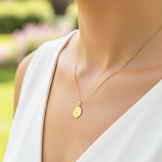 Cuello de modelo usando una cadena con un dije de la Virgen de la Caridad en oro amarillo de 18 quilates de Joyería Caracas.