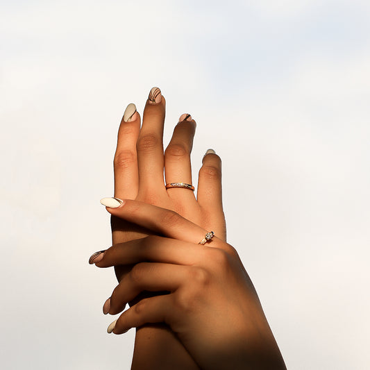 Mano de mujer con anillo pisargolla en oro amarillo de 18 quilates con Diamantes de color blanco, fabricado en Joyería Caracas.