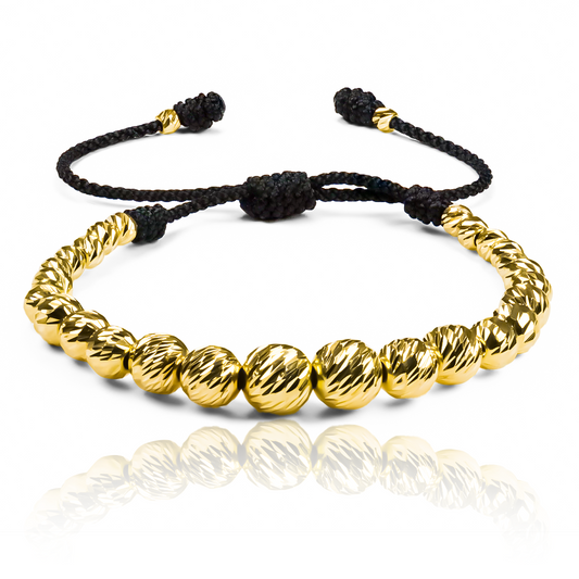 Pulsera Facetadas en Degrade de Joyería Caracas está elaborada en oro 18k, con detalles en hilo terlenca y bisutería de calidad. Con garantía de por vida y sin costo adicional.