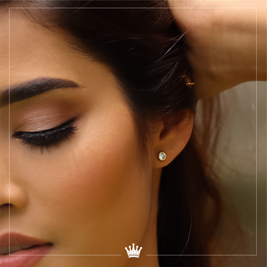 Oreja de mujer con topito embastado en oro amarillo de 18 quilates con cristal de color blanco, hechos en Joyería Caracas.