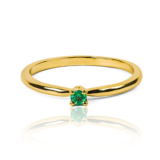 Anillo amsterdam en oro amarillo con una esmeralda central engastada 