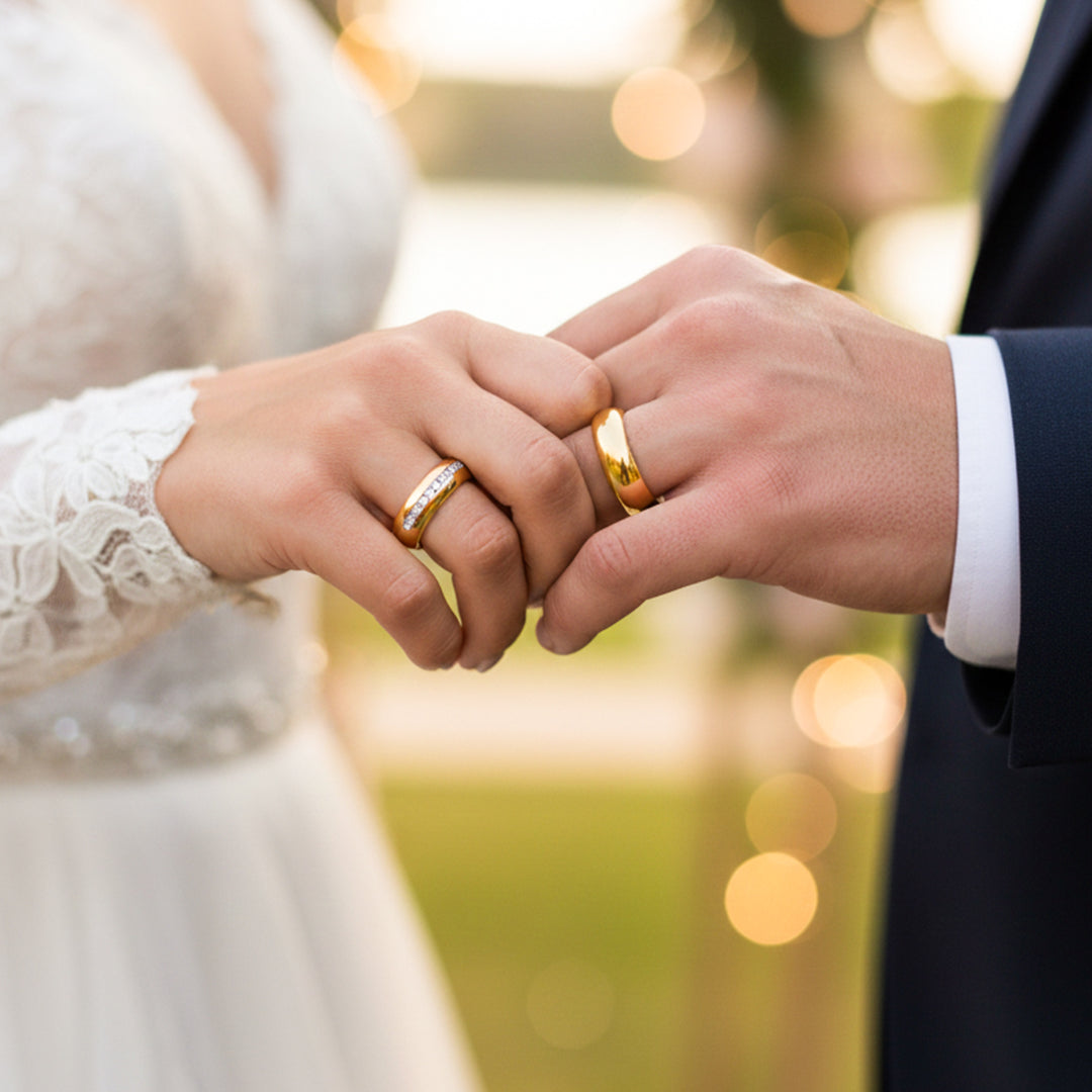Manos de una pareja usando unas argollas de matrimonio en oro amarillo de 18 quilates con cristales de Joyería Caracas. 