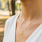 Cuello de modelo usando una cadena con un dije en forma de Cristo en oro amarillo de 18 quilates de Joyería Caracas.