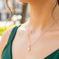 Cuello de modelo usando una cadena con un dije en forma de la Virgen de Guadalupe en oro amarillo de 18 quilates con cristales blancos de Joyería Caracas.