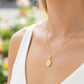 Cuello de modelo usando una cadena con un dije en forma de la Virgen de Guadalupe en oro amarillo de 18 quilates con cristales de Joyería Caracas.