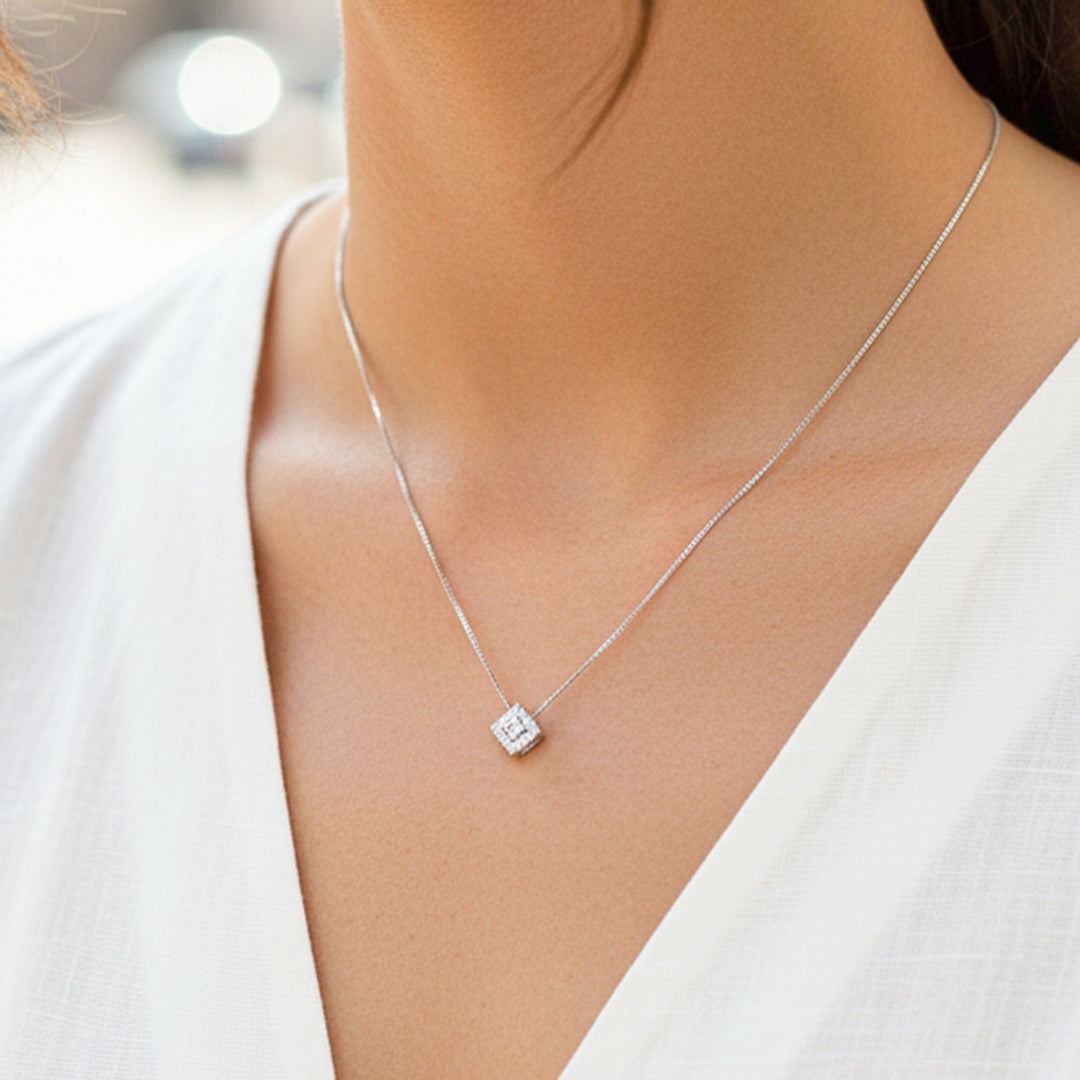 Cuello de modelo usando una cadena con un dije pasante princess en oro blanco de 18 quilates de Joyería Caracas.