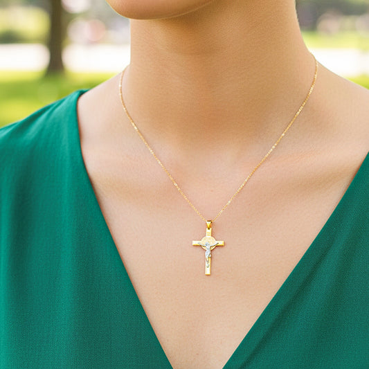 Cuello de modelo usando una cadena con un dije en forma de cruz San Benito laser en oro amarillo y blanco de 18 quilates de Joyería Caracas.