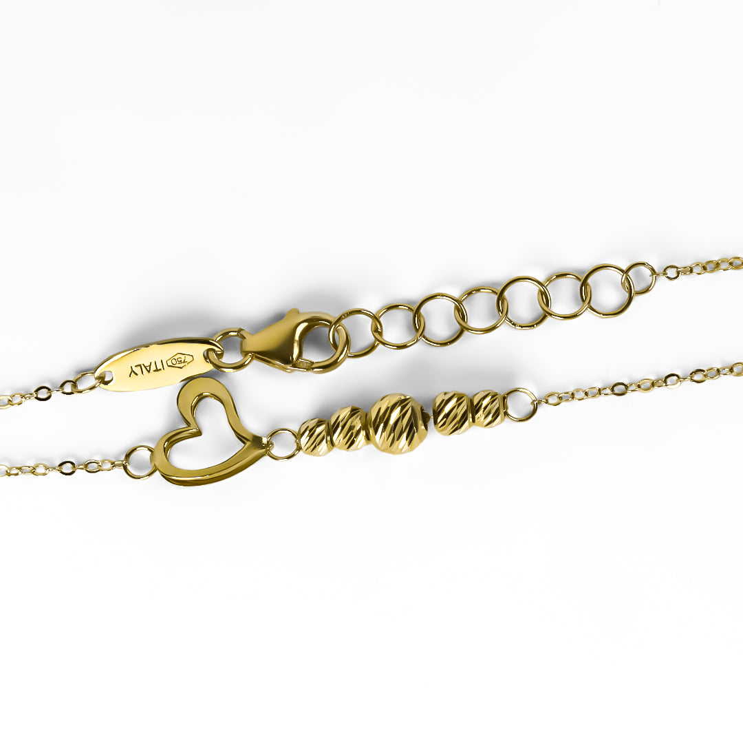 Pulsera spheres and heart. Fabricada en Oro 18K por Joyería Caracas, cuenta con garantía para toda la vida.