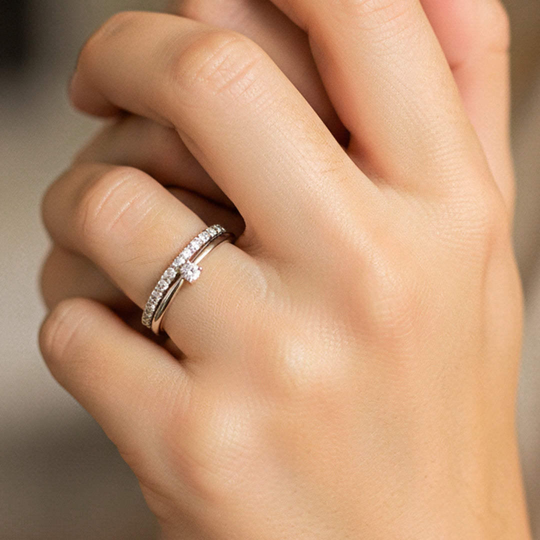 Mano de modelo usando un anillo con pisargolla en oro blanco de 18 quilates con cristales de Joyería Caracas. 