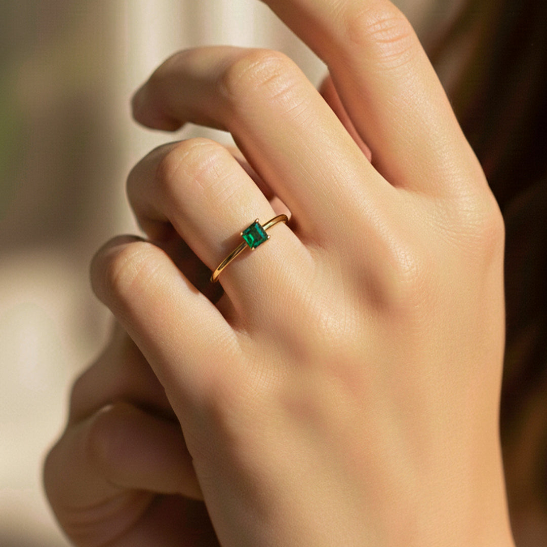 Mano de modelo usando un anillo en oro amarillo de 18 quilates con cristal cuadrado de Joyería Caracas. 