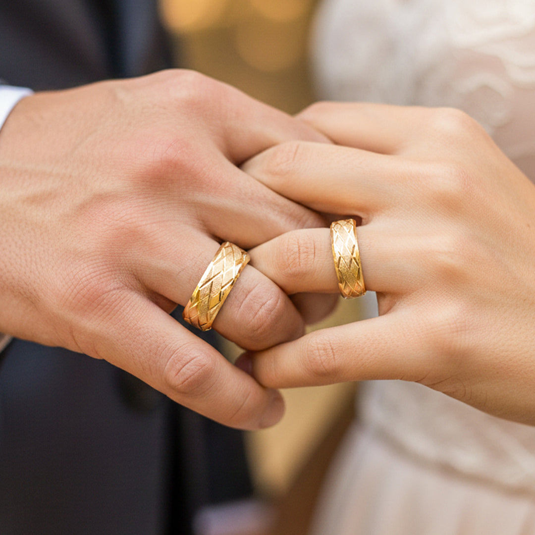 Manos de pareja en matrimonio usando unas argollas diamantadas en oro amarillo de 18 quilates de Joyería Caracas. 