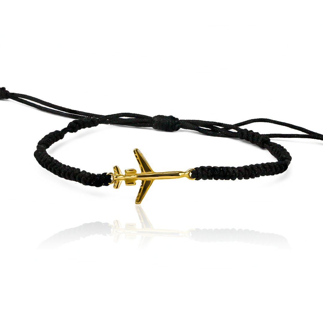 Pulsera Avión de Joyería Caracas está confeccionada en oro 18k, con detalles en hilo coreano y bisutería de calidad. Con garantía de por vida.