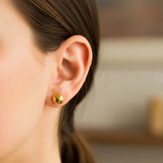 Oreja de modelo usando un topito de esfera diamantada en oro amarillo de 18 quilates de Joyería Caracas. 