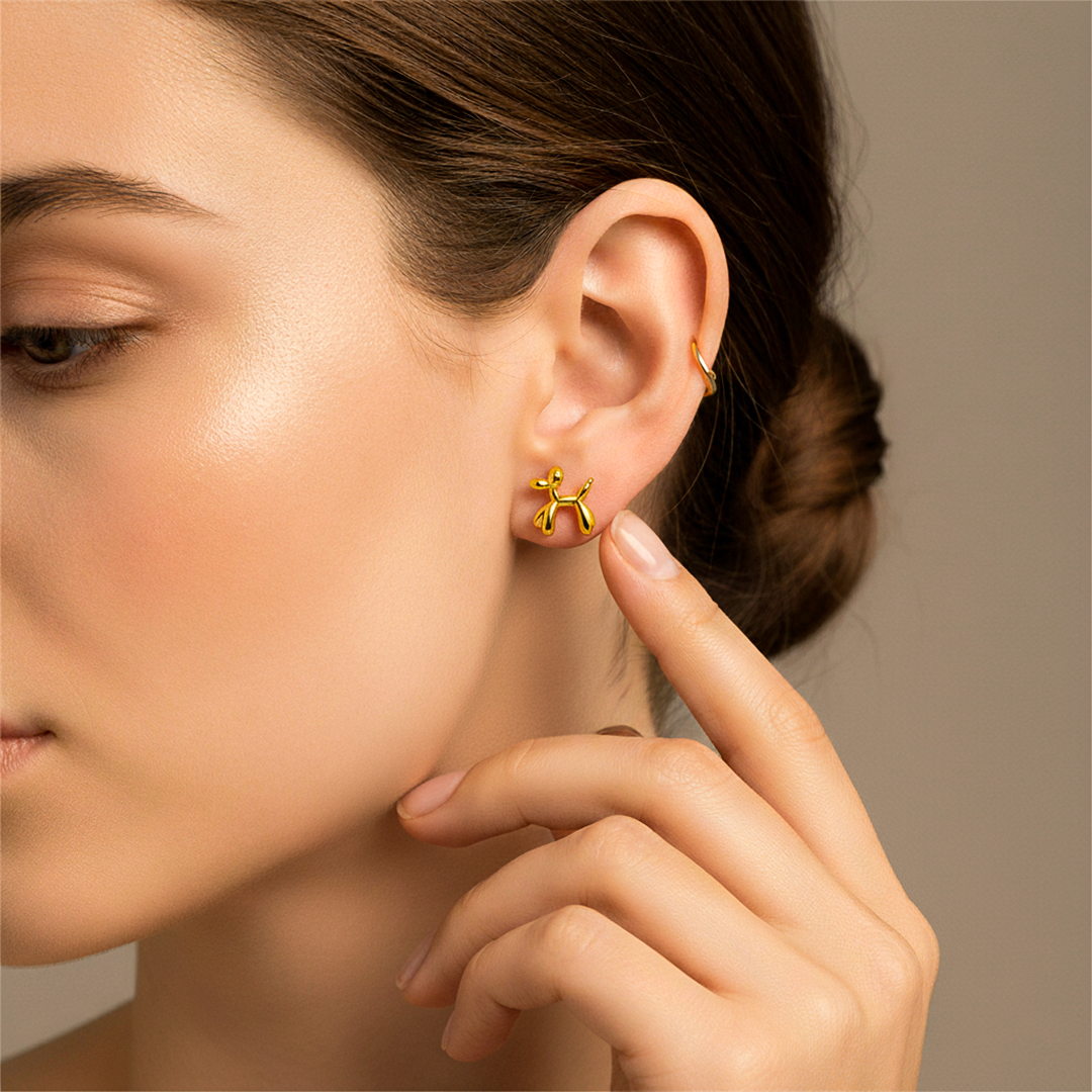 Oreja de modelo usando un topito en forma de perrito en oro amarillo de 18 quilates de Joyería Caracas. 